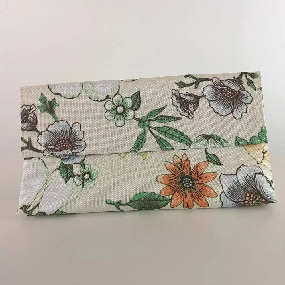 Clinique cream floral print fold over makeup / jewelry bag.